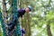 Happy boy climbing in adventure park