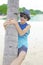 Happy boy is climbing on palm tree