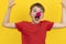 Happy boy with clown nose having fun on holiday. Portrait of child on yellow background