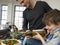 Happy Boy And Father Preparing Salad In Kitchen