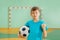 Happy boy, football winner, holding soccer ball