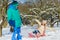 Happy boy and girl sledding in winter outdoor