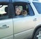 Happy boy and his companion cat in the car