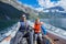 Happy boy with his father driving the motorboat, Norway. They are enjoying the moment.