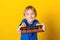 Happy boy holding abacus over yellow background. Mental arithmetic school. Kids development, skill at mental arithmetic