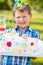 Happy boy holding cake at birthday party