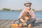 Happy boy hugging his dog by the river