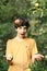 Happy boy juggling apples smile wink on apple tree green garden background