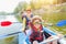 Happy boy kayaking on the river on a sunny day during summer vacation