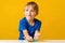 Happy boy makes a slime at table. Homemade popular toy slime. Child plays with slime