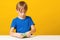 Happy boy makes a slime at table. Homemade popular toy slime. Child plays with slime