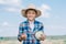 happy boy in panama hat holding ripe vegetables and smiling