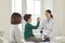 Happy boy patient giving five to smiling woman pediatrician