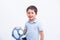 Happy boy playing football. Cute child, young male teen goalkeeper enjoying sport game. Little footballer holding ball, isolated