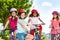 Happy boy riding bicycle with friends in summer