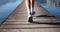 Happy boy running at the lake on the wooden pier. Summer holidays concept