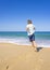 Happy boy running and playing on the summer beach. Young teenager relax and having fun in summer holiday vacation travel