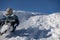 Happy boy sliding down snow hill on sled outdoors in winter, sledging and season concept