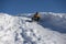 Happy boy sliding down snow hill on sled outdoors in winter, sledging and season concept