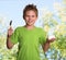 Happy boy with spoon and healthy organic yogurt outdoors.