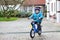 Happy boy of three years riding on bicycle in autumn or winter,