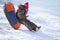 A happy boy up in the air on a tube sledding in the snow