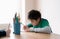 Happy boy using colour pencil drawing or sketching on paper, Portrait  kid siting on table doing homework, Child enjoy art and