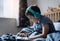 Happy boy wear wireless headphone listening music while sitting in bed, Cute young kid playing game on tablet,Positive child in