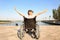 Happy boy in wheelchair near river