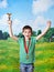 Happy boy winner with cup and medal on nature