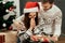 Happy boyfriend and girlfriend couple near christmas tree, beaut