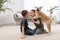 Happy boys with Akita Inu dog on floor in room. Little friends