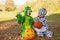 Happy boys in Autumn Halloween costumes sit by pumpkins