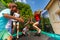 Happy boys and girls jumping on outdoor trampoline