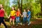 Happy boys and girls walking in the summer forest