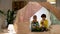 Happy boys reading book in kids tent at home