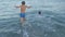 Happy boys swim in the sea. Temperature and sun children fill-up on health fun.