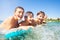 Happy boys swimming in the sea on air mattress