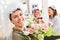 Happy bride with bridal veil and bridal bouquet celebrates with friends