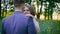 Happy bride comes to groom`s embraces and caresses in the summer park 4K