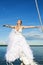 Happy bride flying with open arms