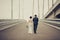 Happy bride and groom celebrating wedding day. Married couple going away on bridge. Long family life road concept. Toned