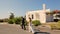 Happy bride and groom on the day of the wedding walking in the background of the hotel