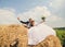 Happy bride and groom on the heap of hey