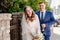 The happy bride and groom standing by the retro fence