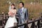 Happy bride and groom walking over bridge (2)