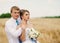 Happy bride and groom on the wheat field . wedding