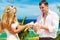 The happy bride and groom with white doves on a tropical beach u