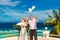 The happy bride and groom with white doves on a tropical beach u