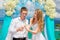 The happy bride and groom with white doves on a tropical beach u